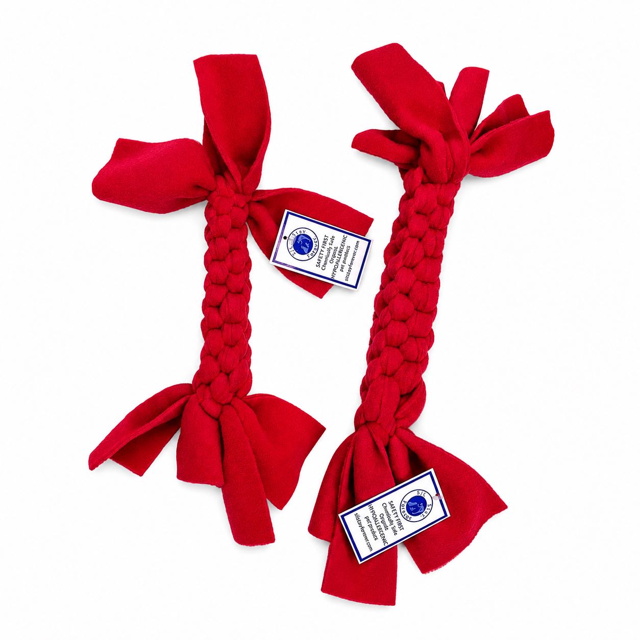 Two red Sit Stay Forever braided dog toys with tags on a white background