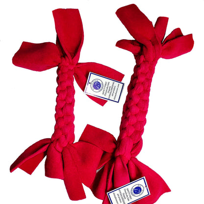 Red and pink Non-Toxic Braided Dog Toy with labels that read "Safety First. Chemically Safe, Organic, Hypoallergenic pet products" the website for Sit.Stay.Forever is shown as siststayforever.com