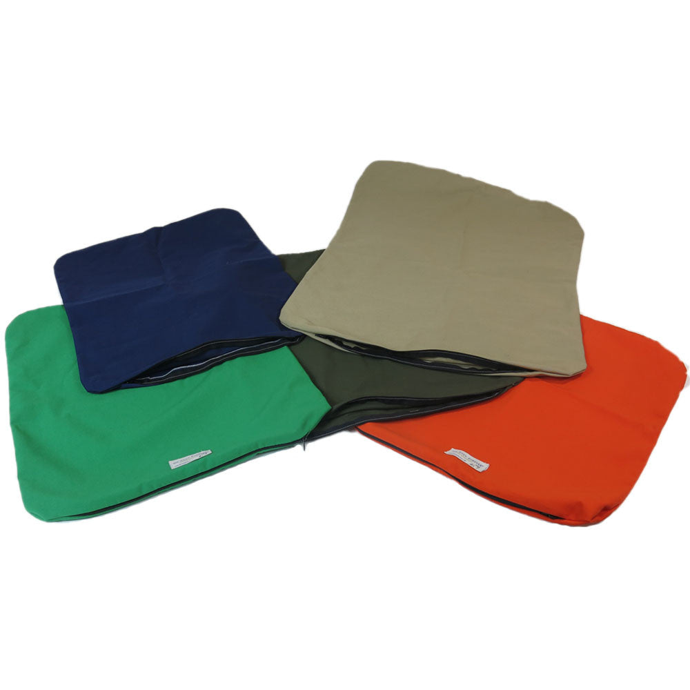 Pile of blue, green, beige, dark green, and orange Organic Cotton Dog Bed Covers.