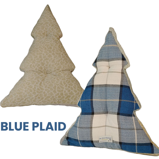 two holiday tree pillows on white background. One blue plaid and one cream flocked animal print