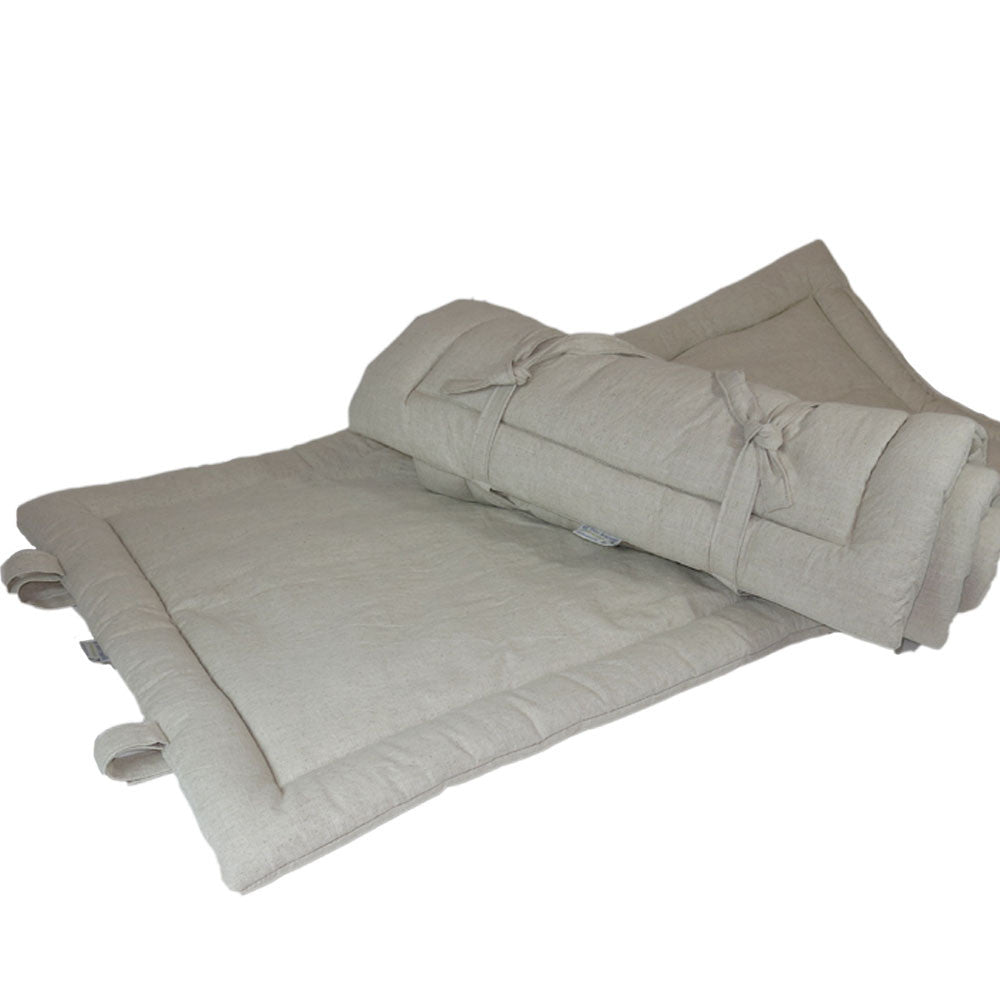 Sit.Stay.Forever. Organic Cotton Human Nap Pad in Beige, rolled-up on top of an extended nap pad.