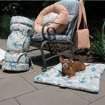 Sit.Stay.Forever. Organic Cotton Human Nap Pads in two nautical designs, laid out on a yard with a dog resting on top of one.