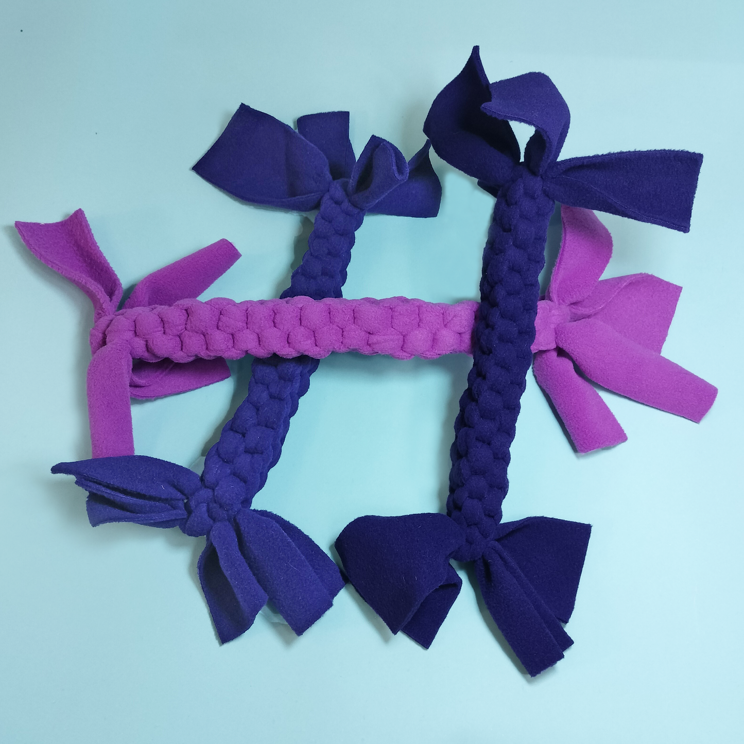 3 braided non toxic dog toys with blue background