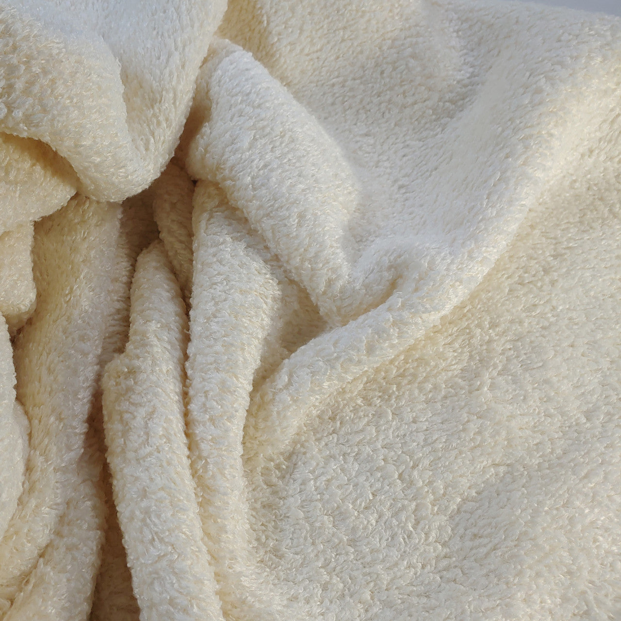 Soft beige texture of the Toxin Free Plush and Curly Velour Throw