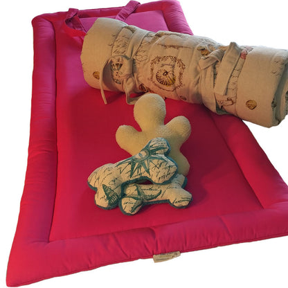 Sit.Stay.Forever. Organic Cotton Human Nap Pad in Pink with rolled-up beige nap pad and plush toys.