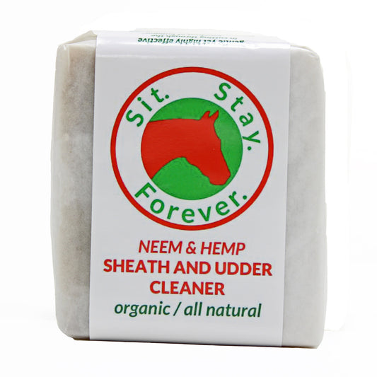 A bar of sheath and udder cleaner soap wrapped in white paper with the label Sit.Stay.Forever. The label reads Neem & Hemp Sheath and Udder Cleaner, organic/all natural.